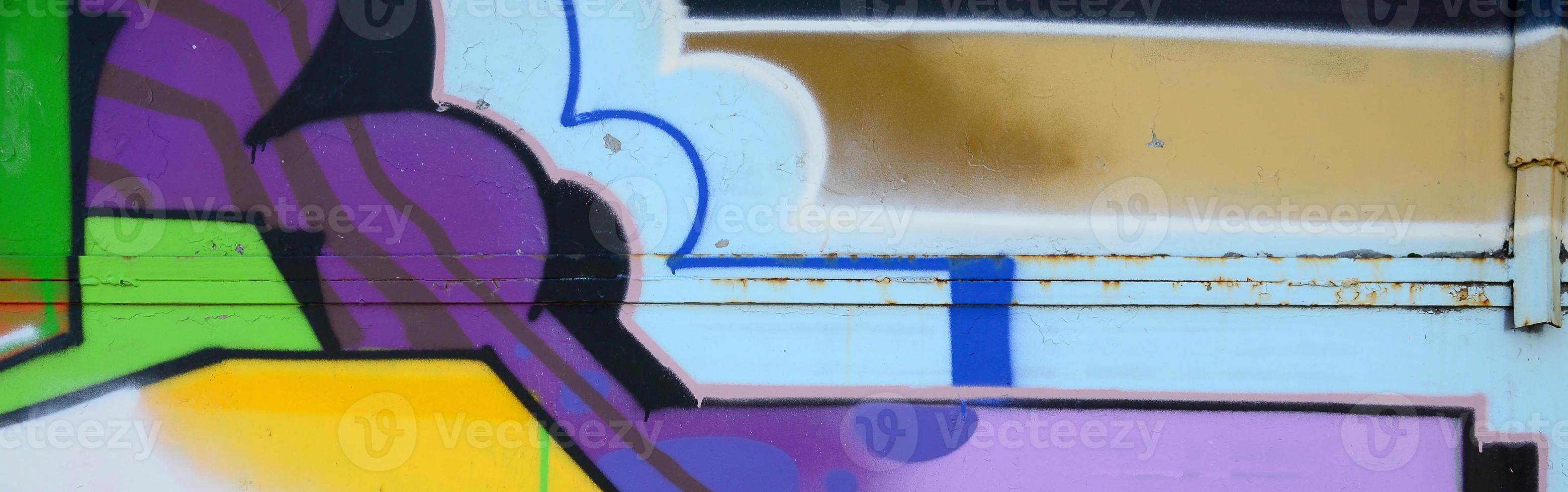 Fragment of graffiti drawings. The old wall decorated with paint stains in the style of street art culture. Multicolored background texture photo