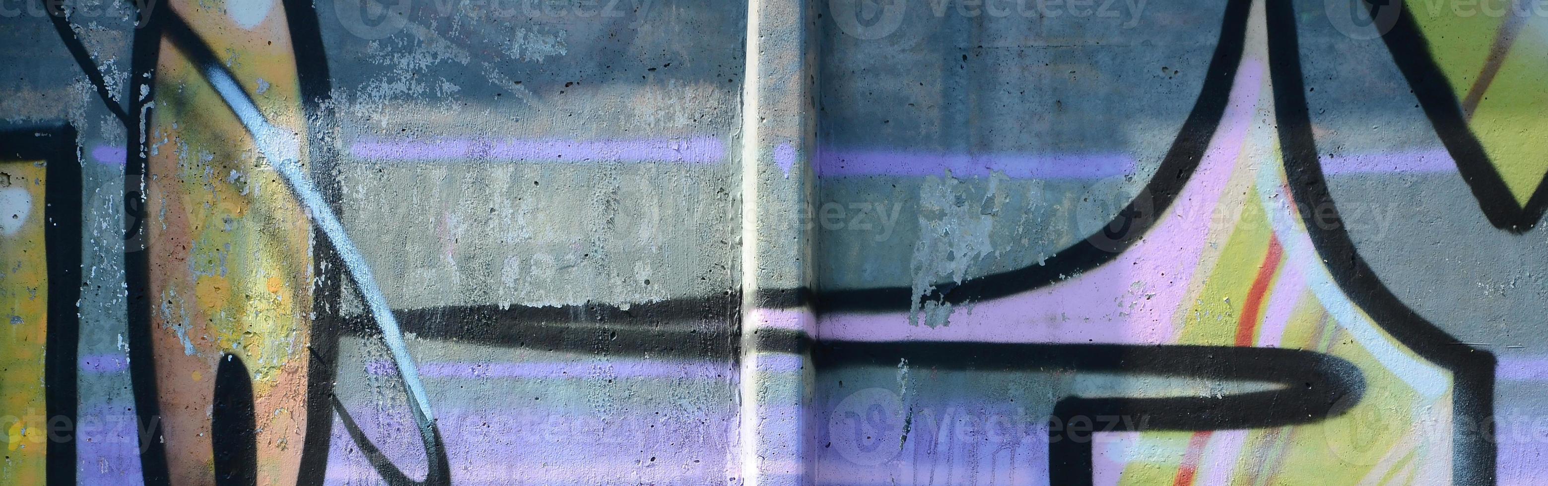 Fragment of graffiti drawings. The old wall decorated with paint stains in the style of street art culture. Multicolored background texture photo