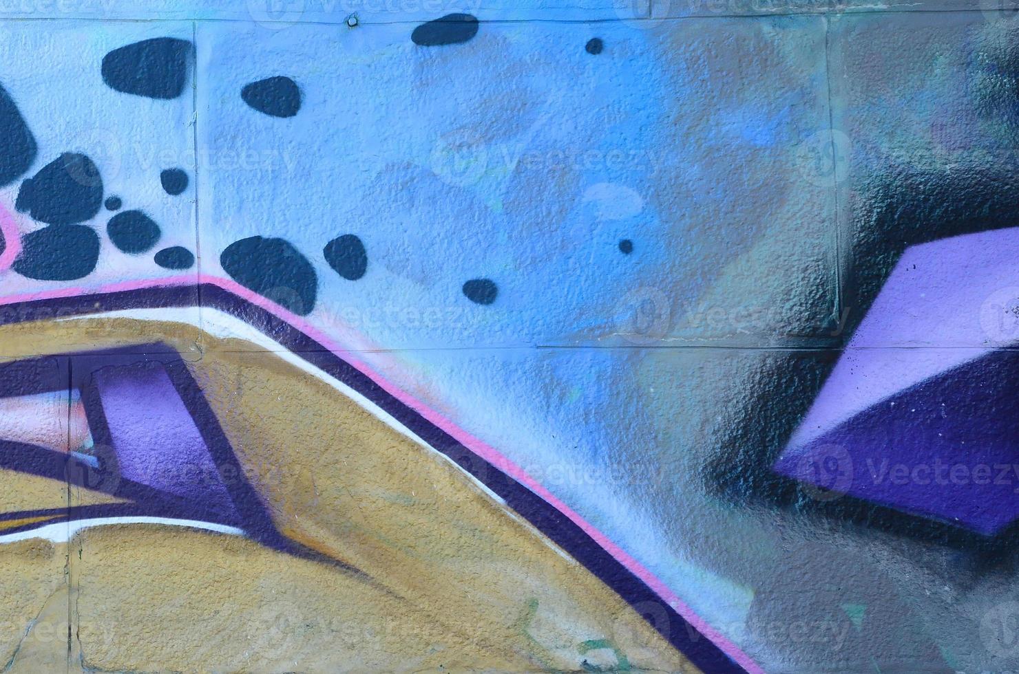 Fragment of graffiti drawings. The old wall decorated with paint stains in the style of street art culture. Colored background texture in purple tones photo