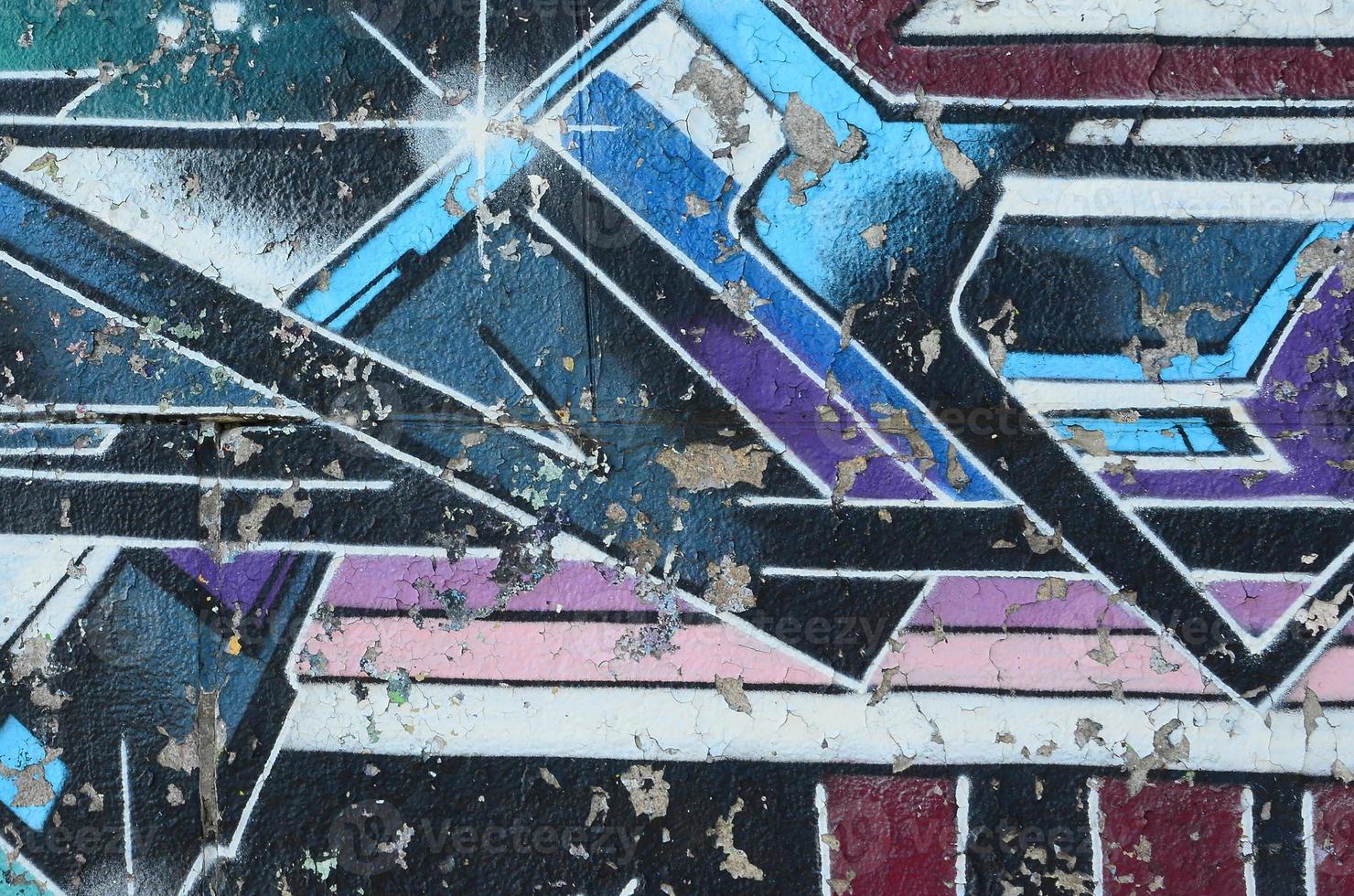 Fragment of graffiti drawings. The old wall decorated with paint stains in the style of street art culture. Multicolored background texture photo