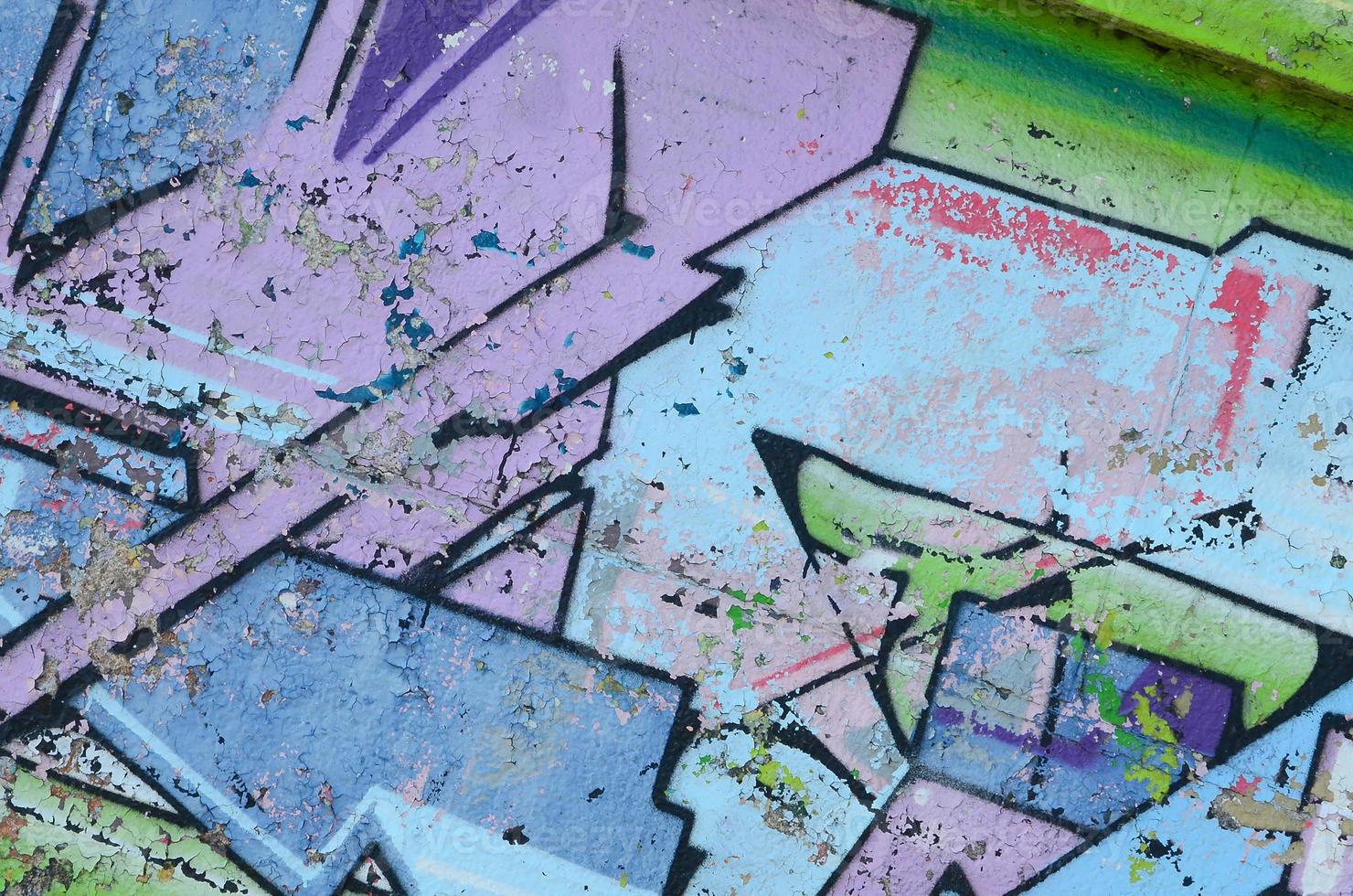 Fragment of graffiti drawings. The old wall decorated with paint stains in the style of street art culture. Colored background texture in cold tones photo
