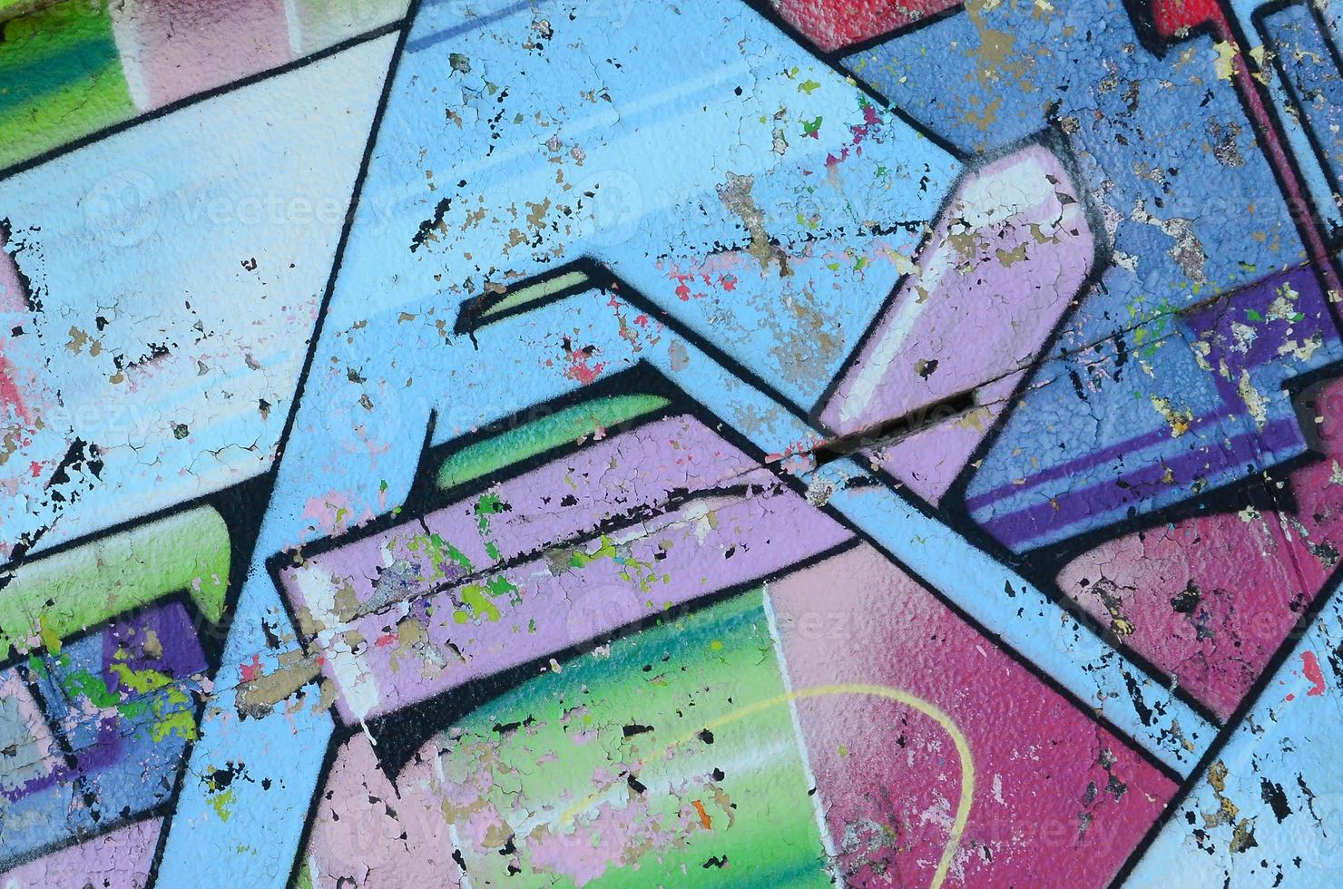 Fragment of graffiti drawings. The old wall decorated with paint stains in the style of street art culture. Colored background texture in cold tones photo