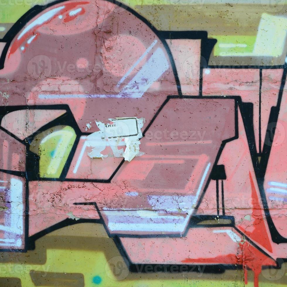 Fragment of graffiti drawings. The old wall decorated with paint stains in the style of street art culture. Colored background texture in warm tones photo