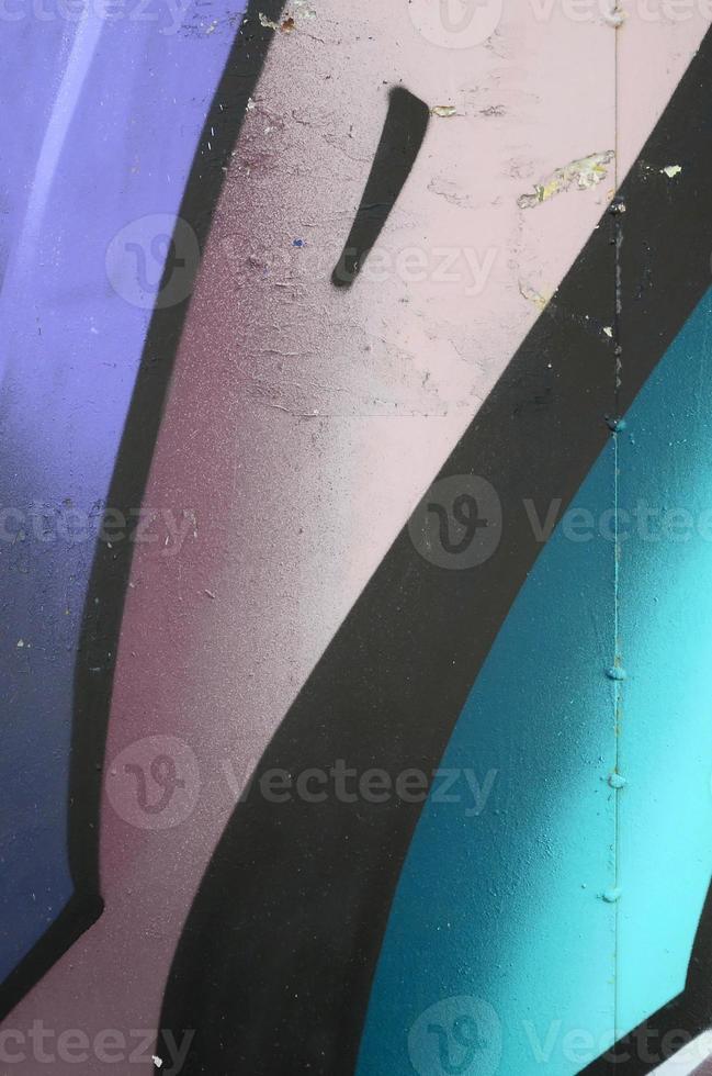 Fragment of graffiti drawings. The old wall decorated with paint stains in the style of street art culture. Colored background texture in cold tones photo