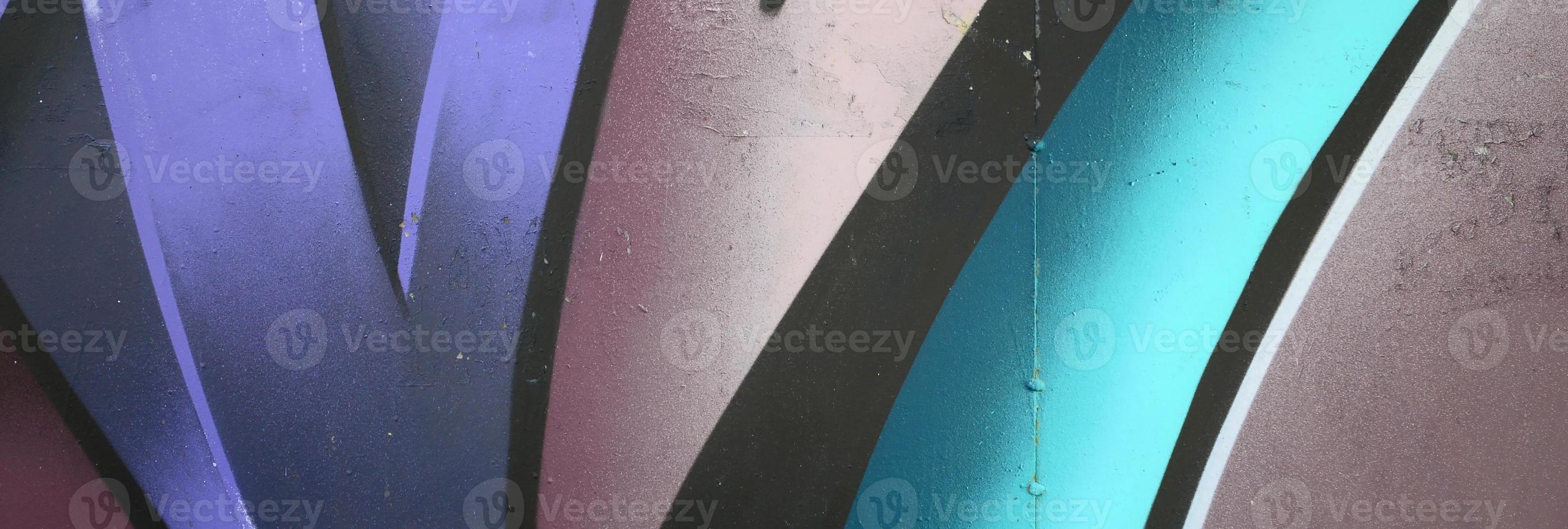 Fragment of graffiti drawings. The old wall decorated with paint stains in the style of street art culture. Colored background texture in cold tones photo