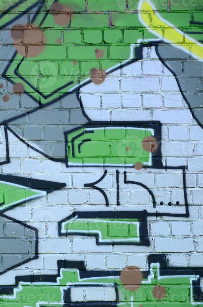 Fragment of graffiti drawings. The old wall decorated with paint stains in the style of street art culture. Colored background texture in green tones photo