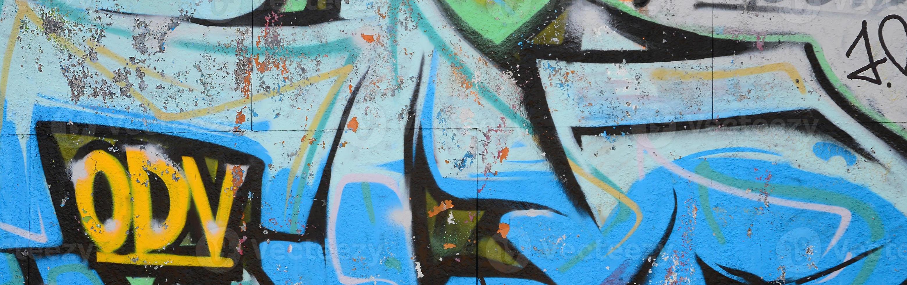Fragment of graffiti drawings. The old wall decorated with paint stains in the style of street art culture. Colored background texture in cold tones photo