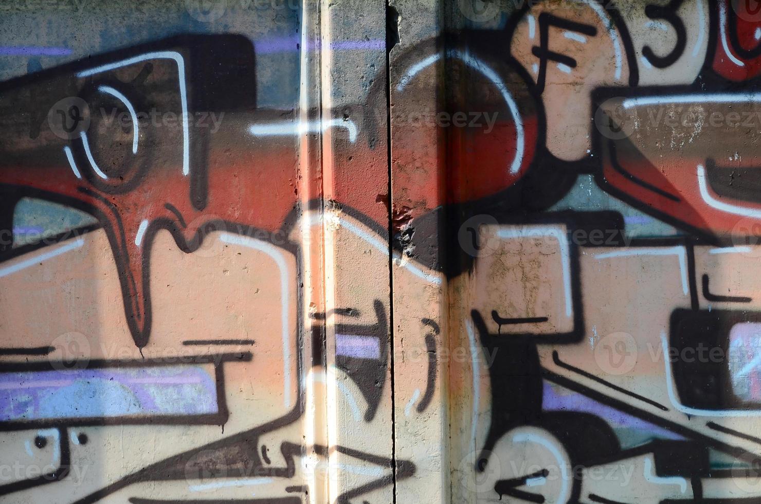 Fragment of graffiti drawings. The old wall decorated with paint stains in the style of street art culture. Colored background texture in warm tones photo