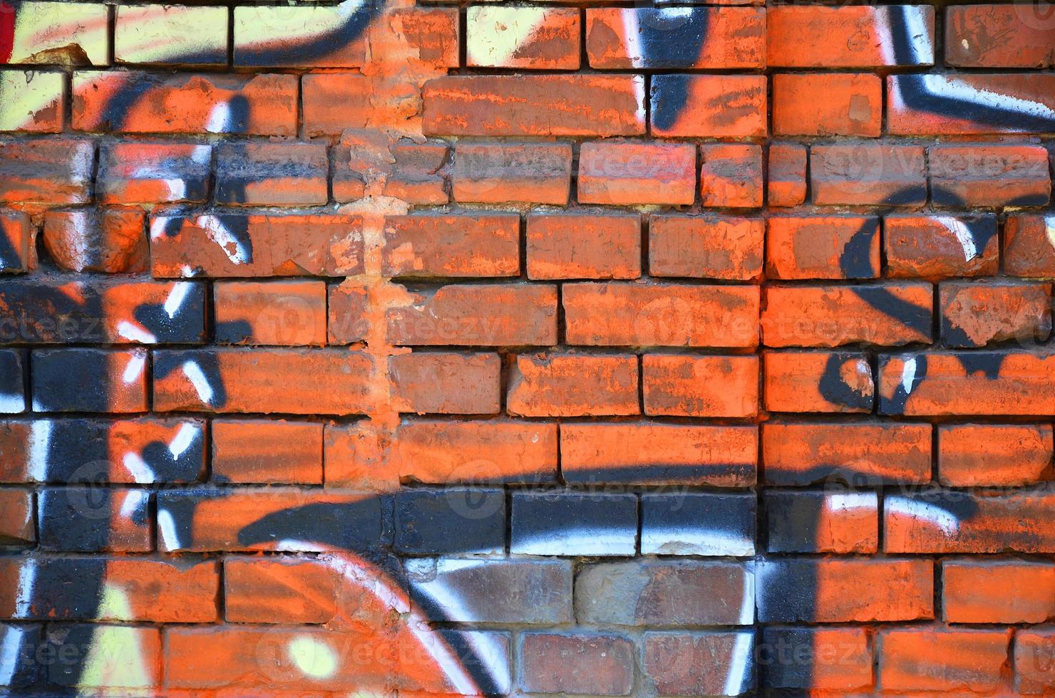 Fragment of an old colored graffiti drawing on the wall. Background image as an illustration of street art, vandalism and wall painting with aerosol paint photo