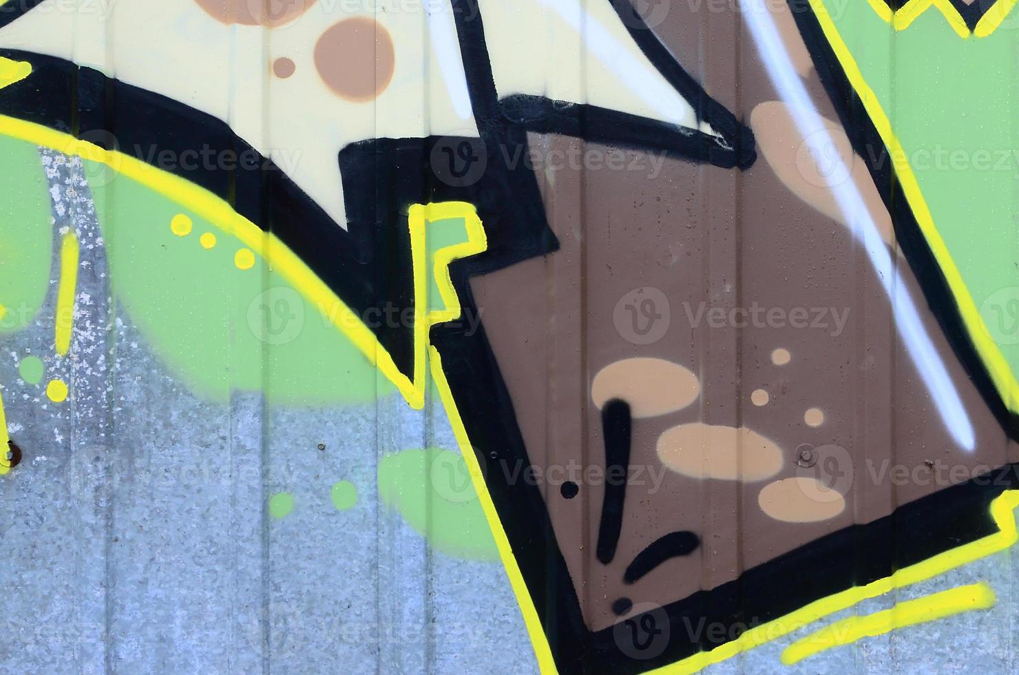 Fragment of graffiti drawings. The old wall decorated with paint stains in the style of street art culture. Colored background texture photo