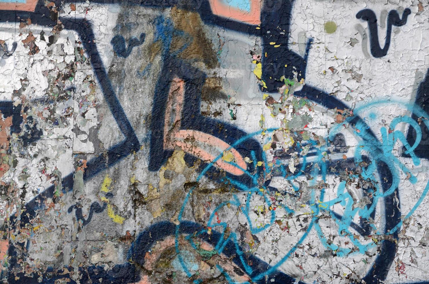 A fragment of graffiti drawing using contours, applied to the wall with the help of cans with aerosol paints over the colored filling areas. Background texture of street art and vandalism photo