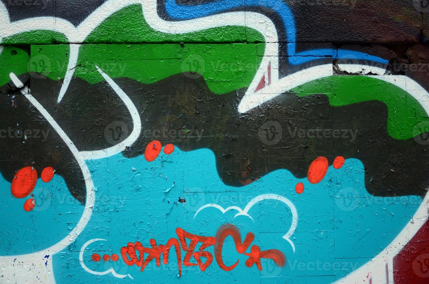 A fragment of graffiti drawing using contours, applied to the wall with the help of cans with aerosol paints over the colored filling areas. Background texture of street art and vandalism photo