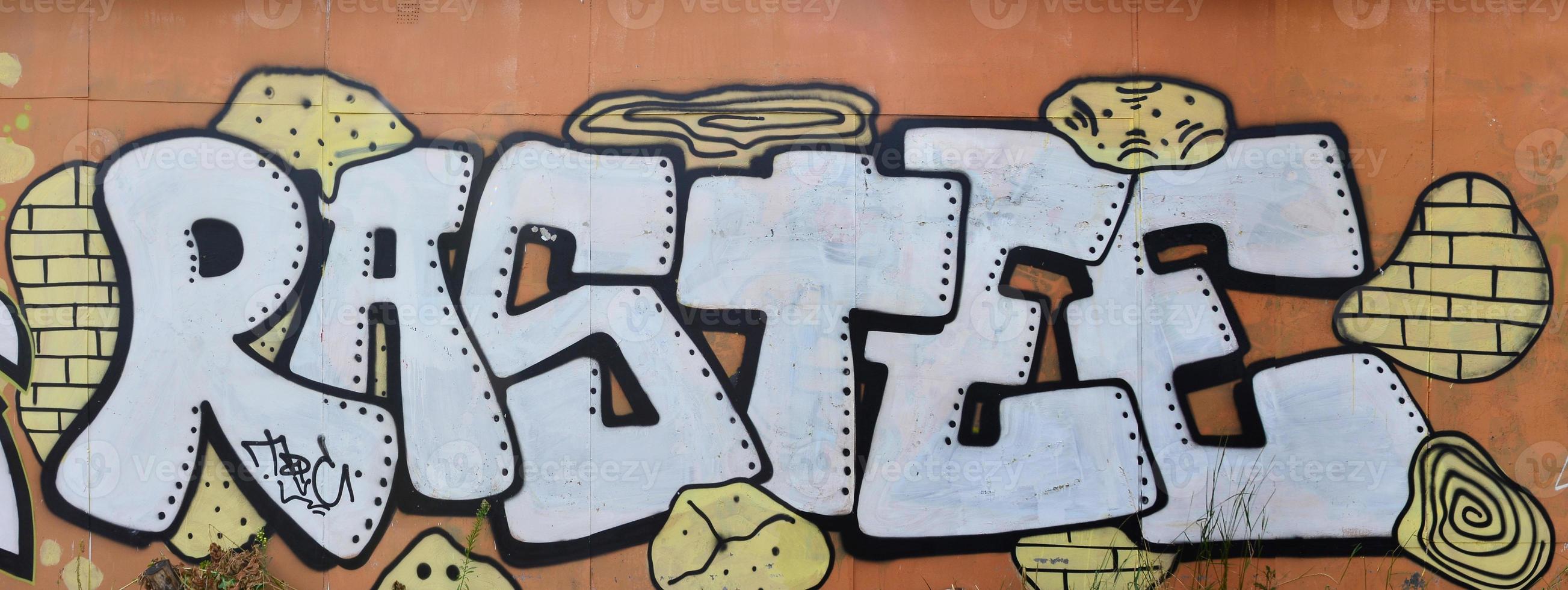 A photograph of a detailed wall artwork. Graffiti drawing is made with white paint with black outlines and has a monophonic orange background. Texture of wall with graffiti decoration photo