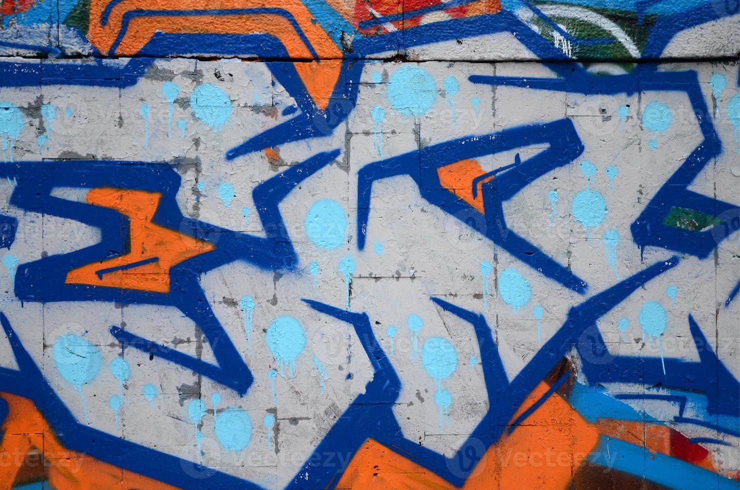 A fragment of graffiti drawing using contours, applied to the wall with the help of cans with aerosol paints over the colored filling areas. Background texture of street art and vandalism photo