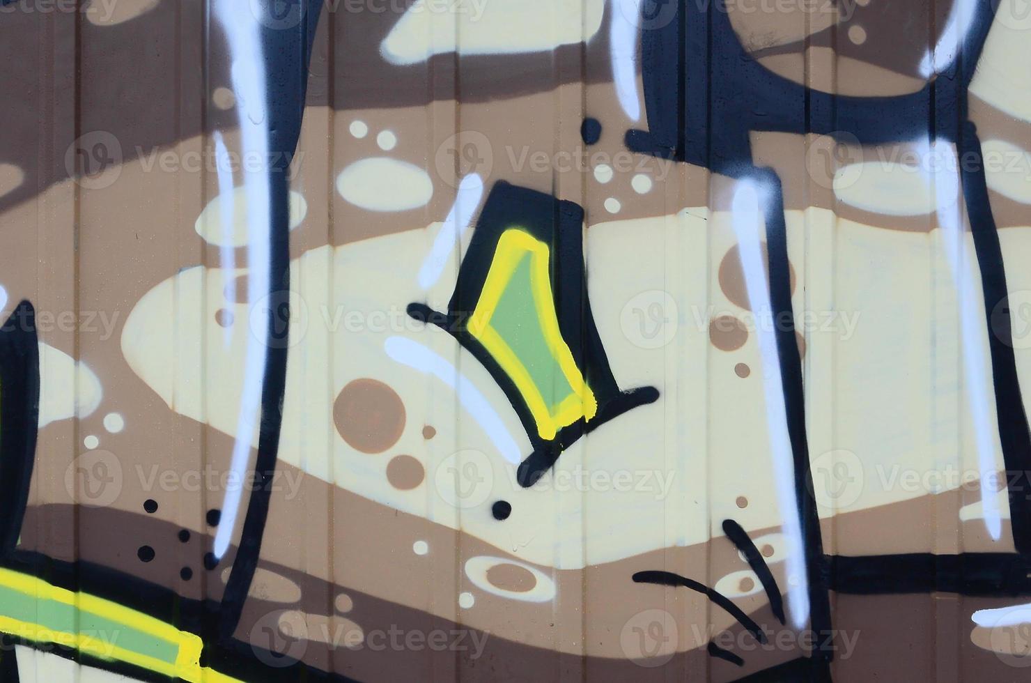 Fragment of graffiti drawings. The old wall decorated with paint stains in the style of street art culture. Colored background texture photo