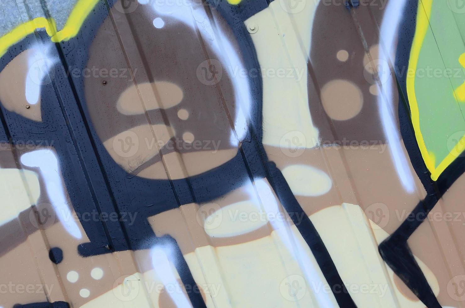 Fragment of graffiti drawings. The old wall decorated with paint stains in the style of street art culture. Colored background texture photo