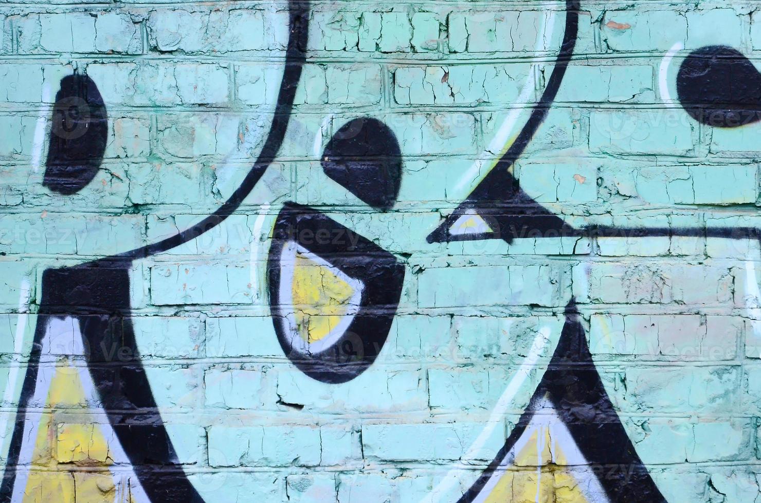 Fragment of graffiti drawings. The old wall decorated with paint stains in the style of street art culture. Colored background texture photo