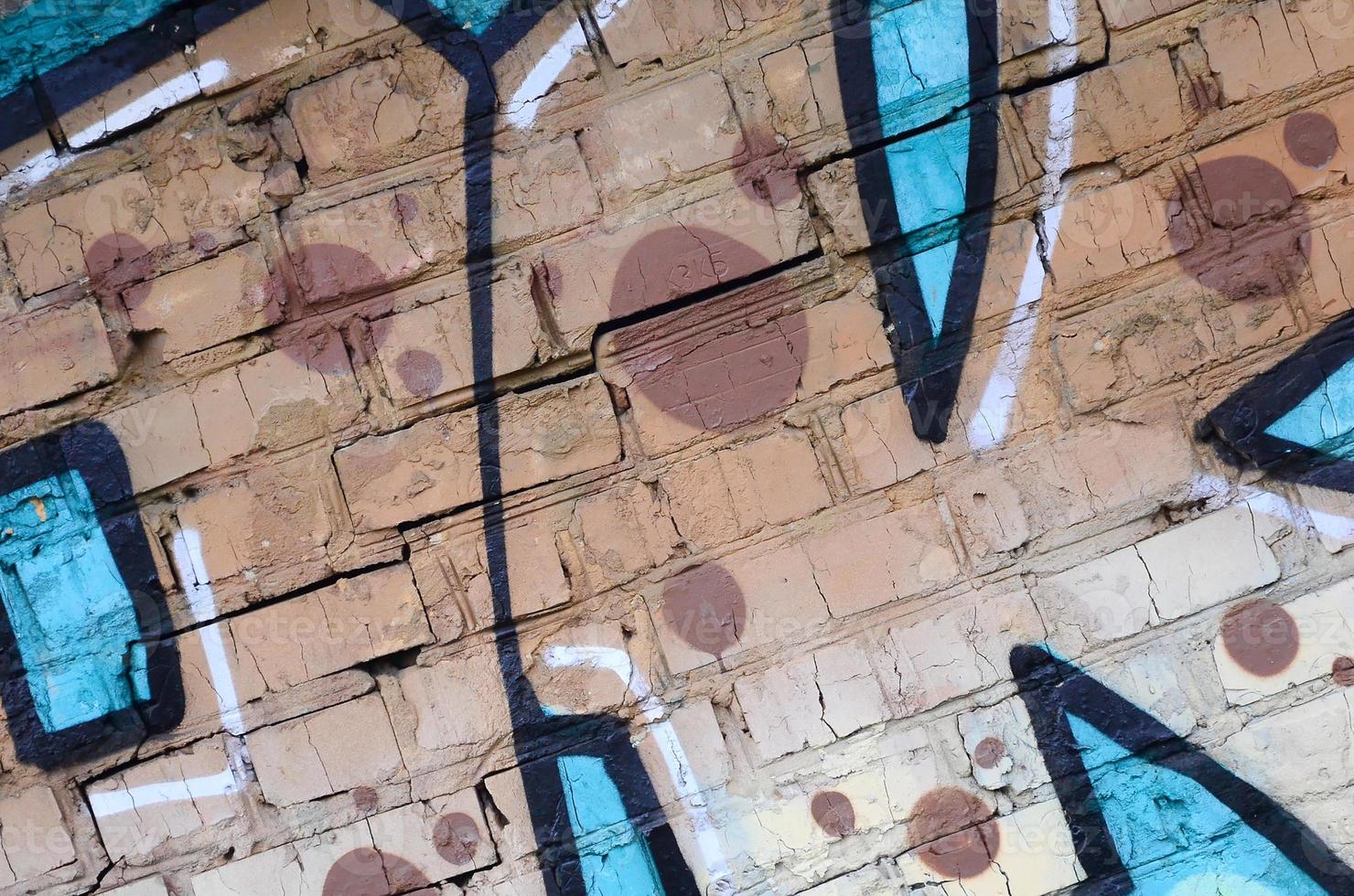 Fragment of graffiti drawings. The old wall decorated with paint stains in the style of street art culture. Colored background texture photo