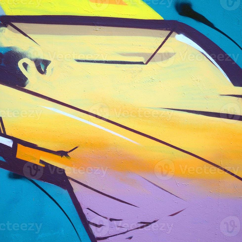 Fragment of graffiti drawings. The old wall decorated with paint stains in the style of street art culture. Colored background texture photo