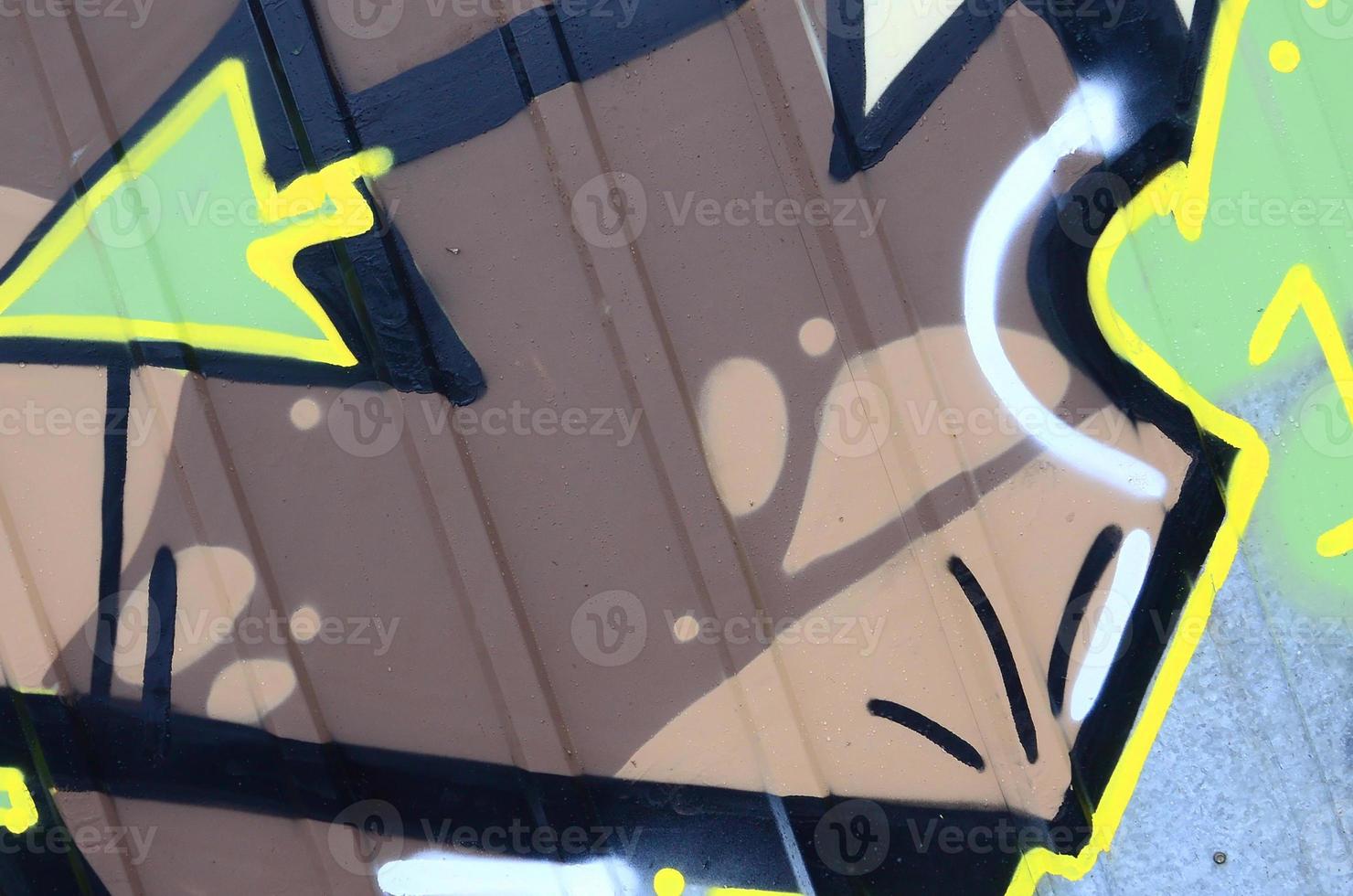 Fragment of graffiti drawings. The old wall decorated with paint stains in the style of street art culture. Colored background texture photo