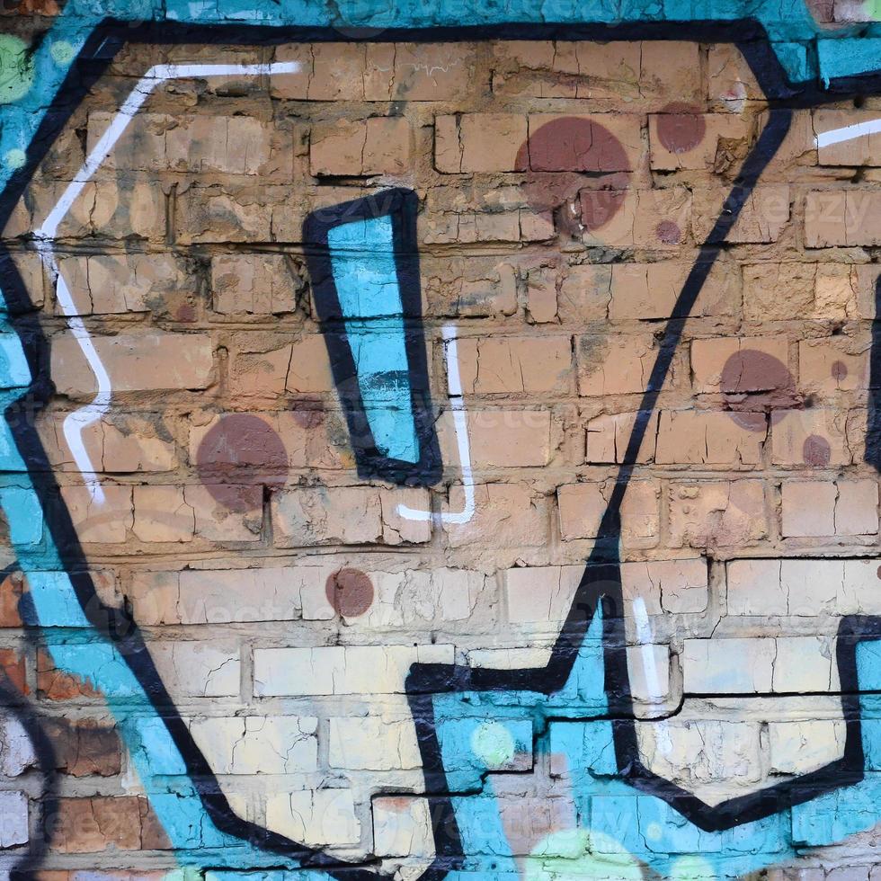 Fragment of graffiti drawings. The old wall decorated with paint stains in the style of street art culture. Colored background texture photo