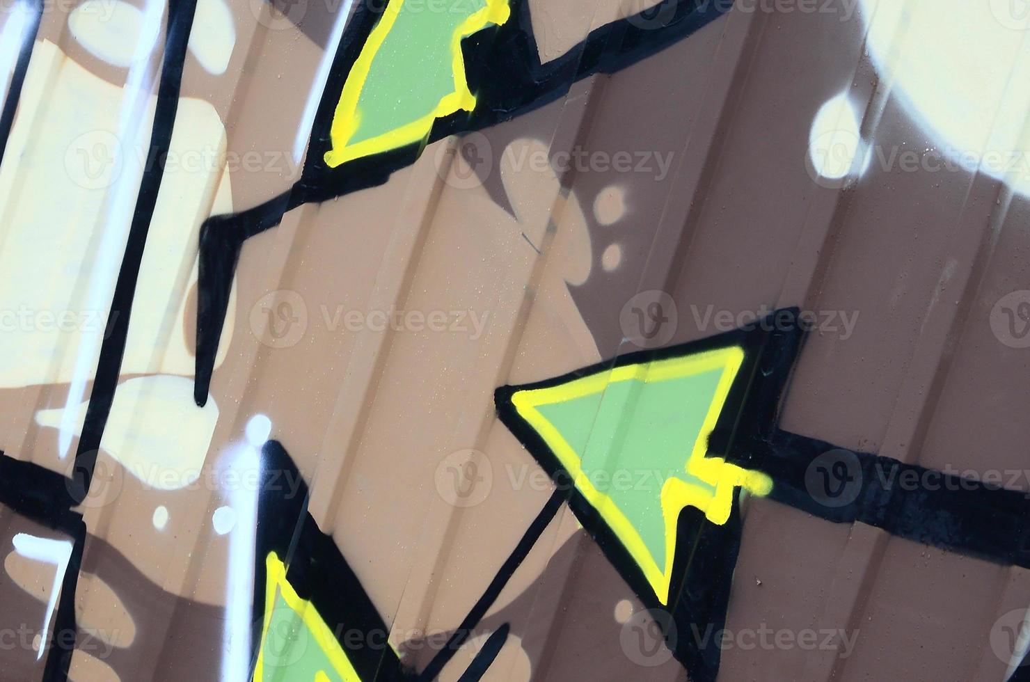 Fragment of graffiti drawings. The old wall decorated with paint stains in the style of street art culture. Colored background texture photo