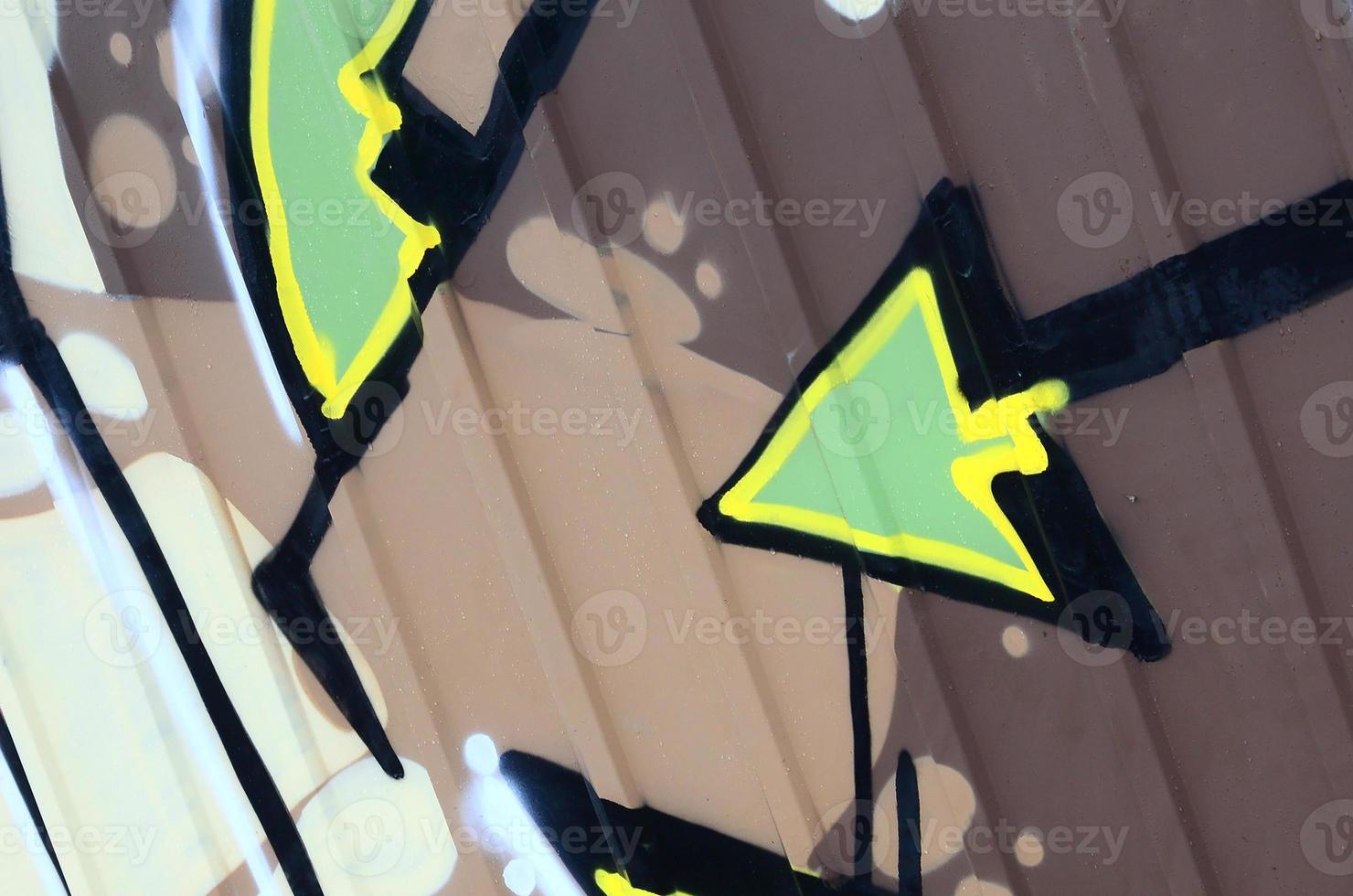 Fragment of graffiti drawings. The old wall decorated with paint stains in the style of street art culture. Colored background texture photo