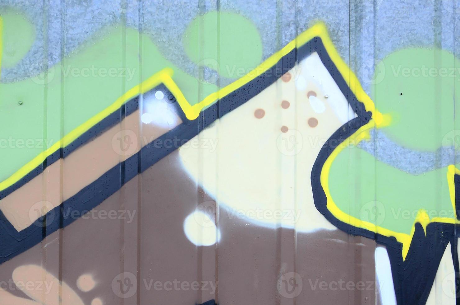 Fragment of graffiti drawings. The old wall decorated with paint stains in the style of street art culture. Colored background texture photo