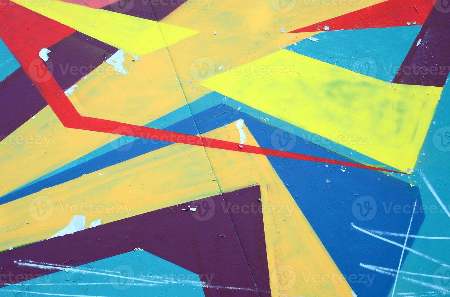Fragment of graffiti drawings. The old wall decorated with paint stains in the style of street art culture. Colored background texture photo