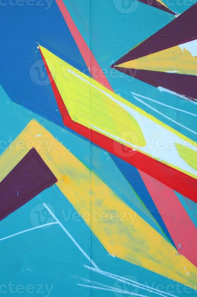 Fragment of graffiti drawings. The old wall decorated with paint stains in the style of street art culture. Colored background texture photo