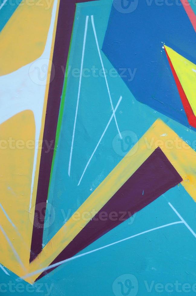 Fragment of graffiti drawings. The old wall decorated with paint stains in the style of street art culture. Colored background texture photo