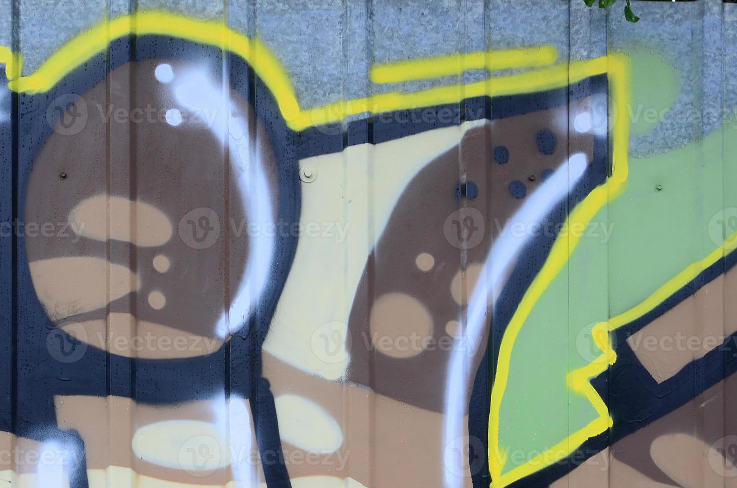 Fragment of graffiti drawings. The old wall decorated with paint stains in the style of street art culture. Colored background texture photo