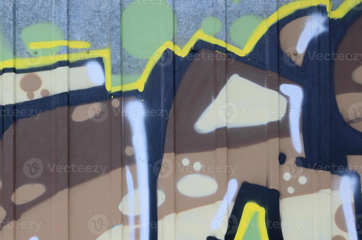 Fragment of graffiti drawings. The old wall decorated with paint stains in the style of street art culture. Colored background texture photo