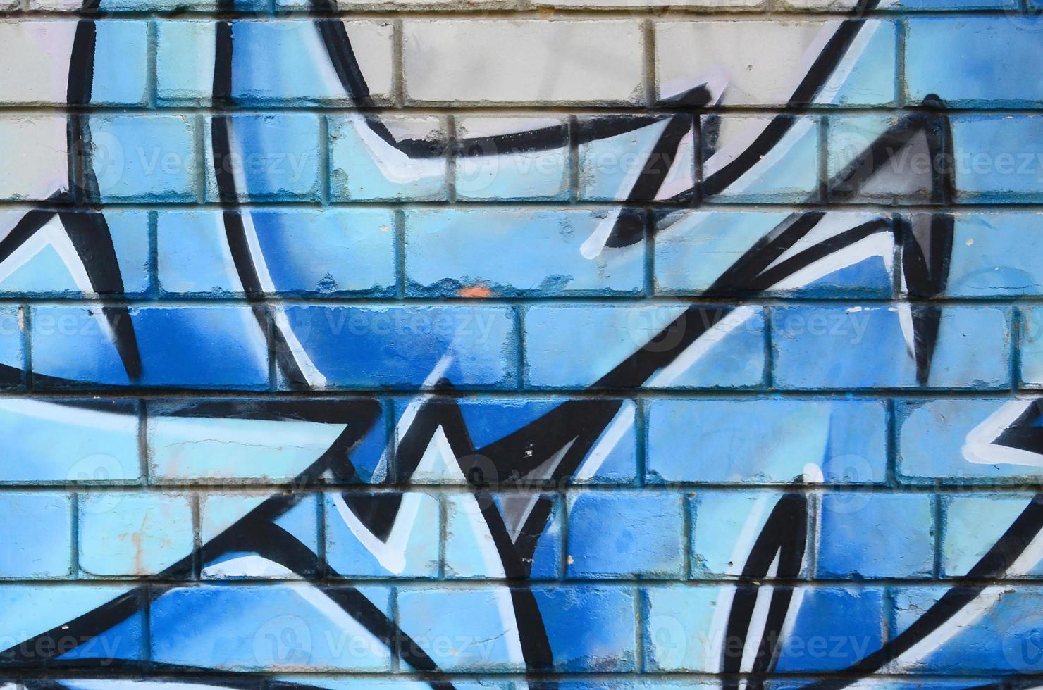 Fragment of graffiti drawings. The old wall decorated with paint stains in the style of street art culture. Colored background texture photo