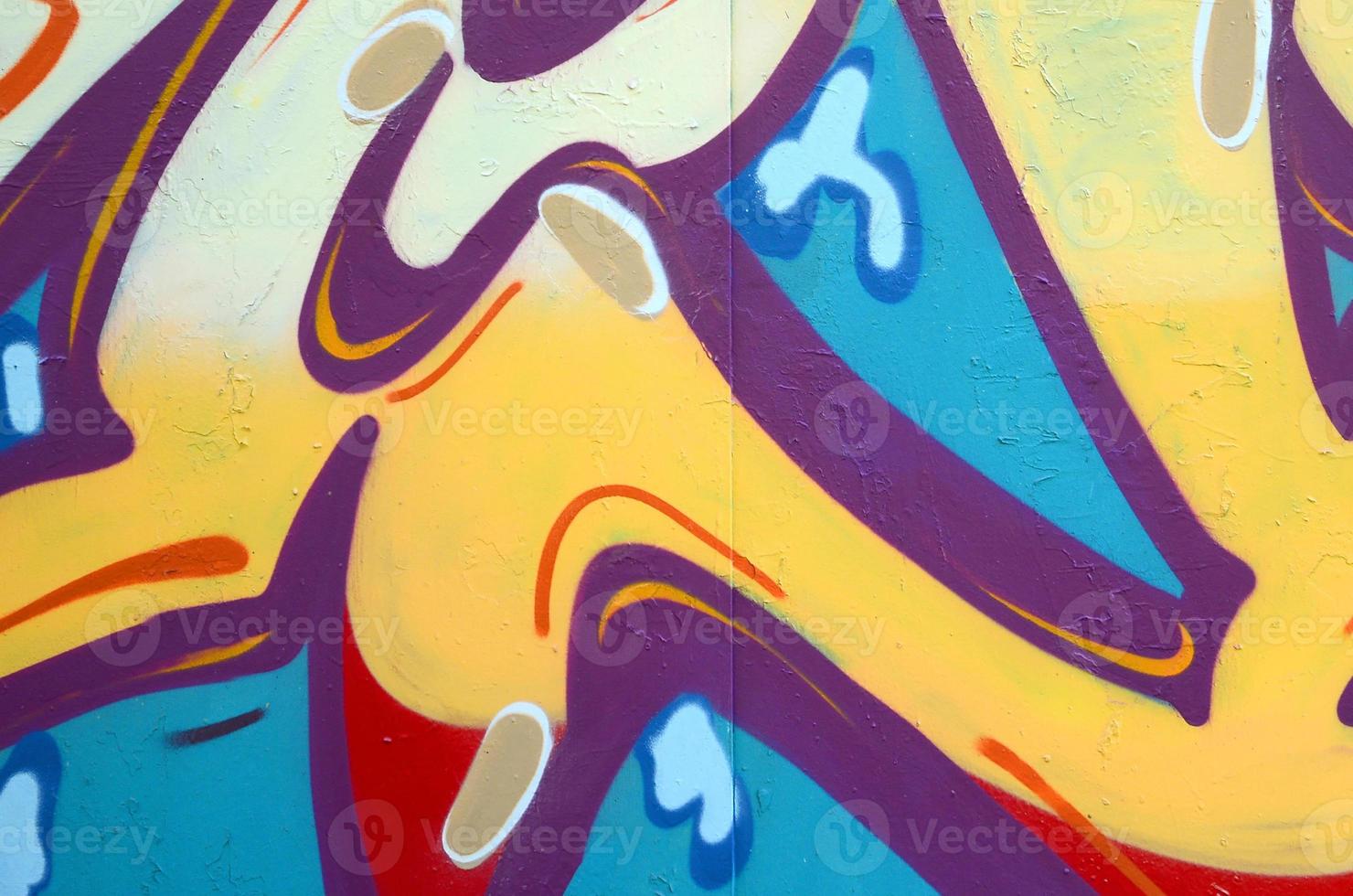 Fragment of graffiti drawings. The old wall decorated with paint stains in the style of street art culture. Colored background texture photo