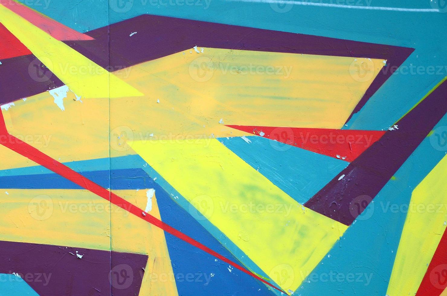 Fragment of graffiti drawings. The old wall decorated with paint stains in the style of street art culture. Colored background texture photo