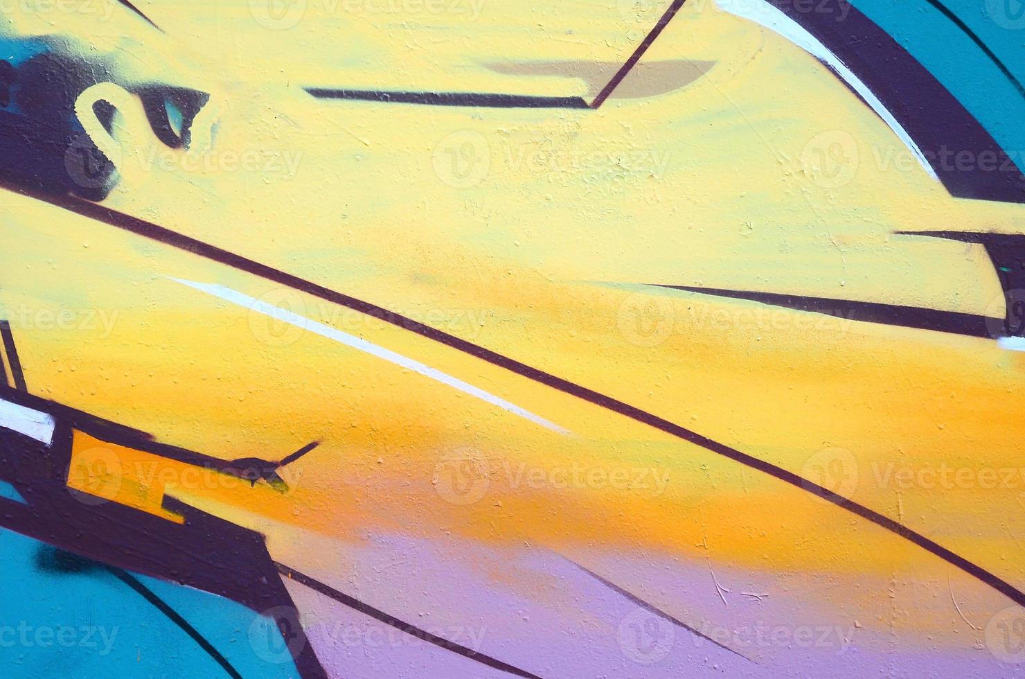Fragment of graffiti drawings. The old wall decorated with paint stains in the style of street art culture. Colored background texture photo