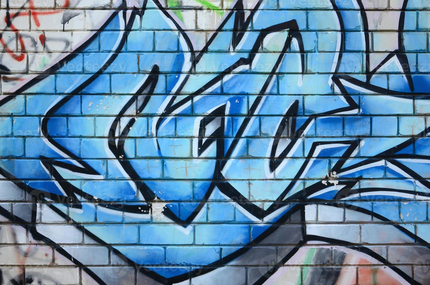 Fragment of graffiti drawings. The old wall decorated with paint stains in the style of street art culture. Colored background texture photo