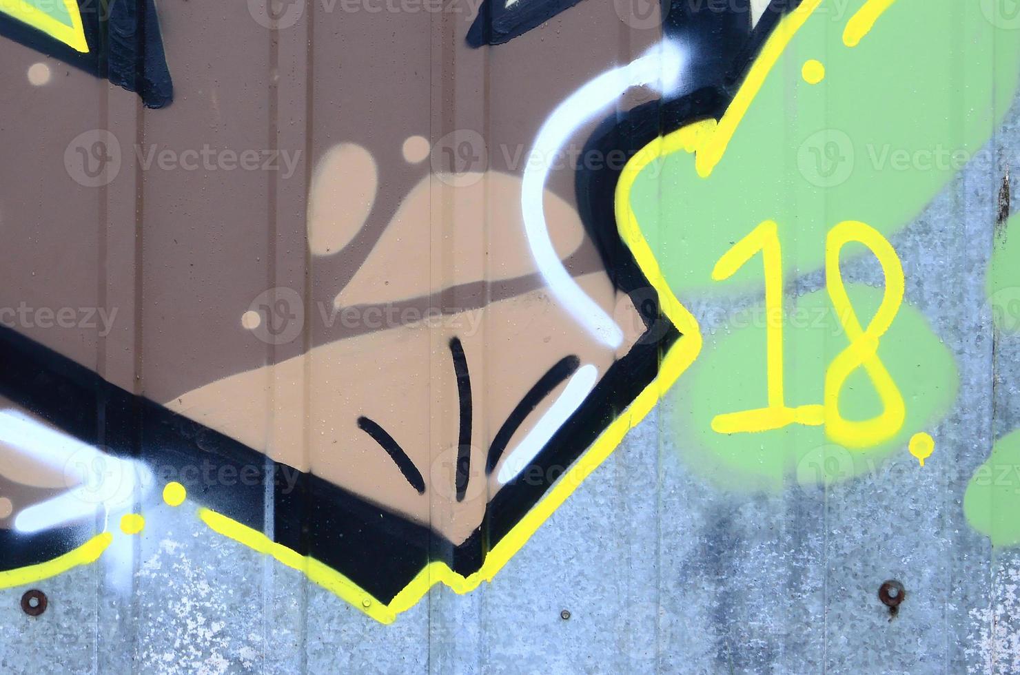 Fragment of graffiti drawings. The old wall decorated with paint stains in the style of street art culture. Colored background texture photo