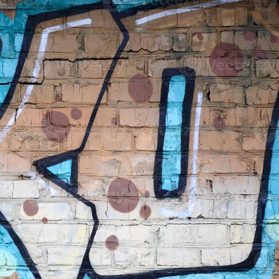 Fragment of graffiti drawings. The old wall decorated with paint stains in the style of street art culture. Colored background texture photo