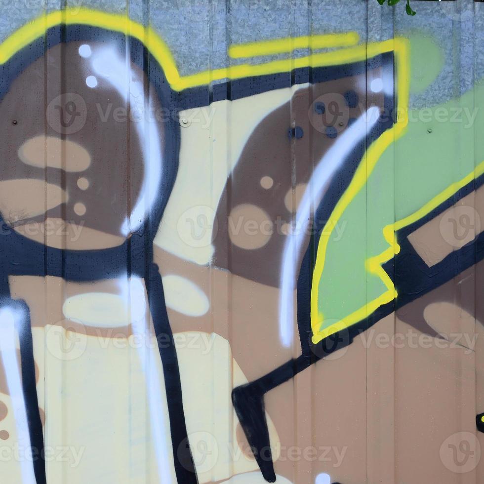 Fragment of graffiti drawings. The old wall decorated with paint stains in the style of street art culture. Colored background texture photo