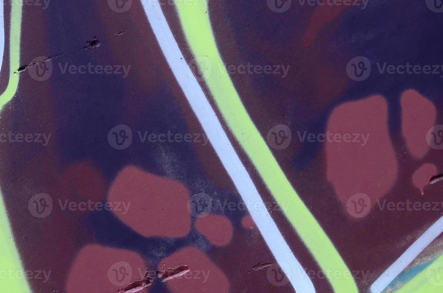 Fragment of graffiti drawings. The old wall decorated with paint stains in the style of street art culture. Colored background texture photo