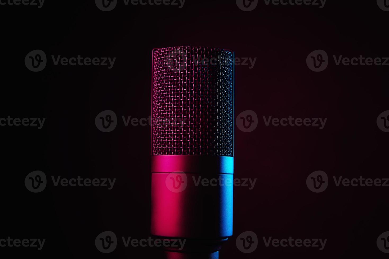 Studio microphone on dark background with neon lights photo