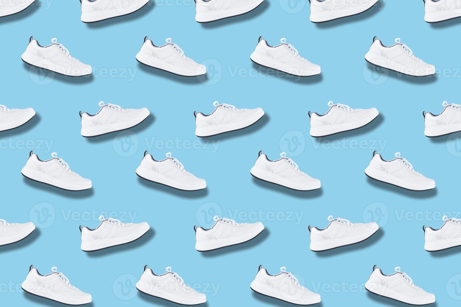 White sneakers seamless pattern on blue background photo