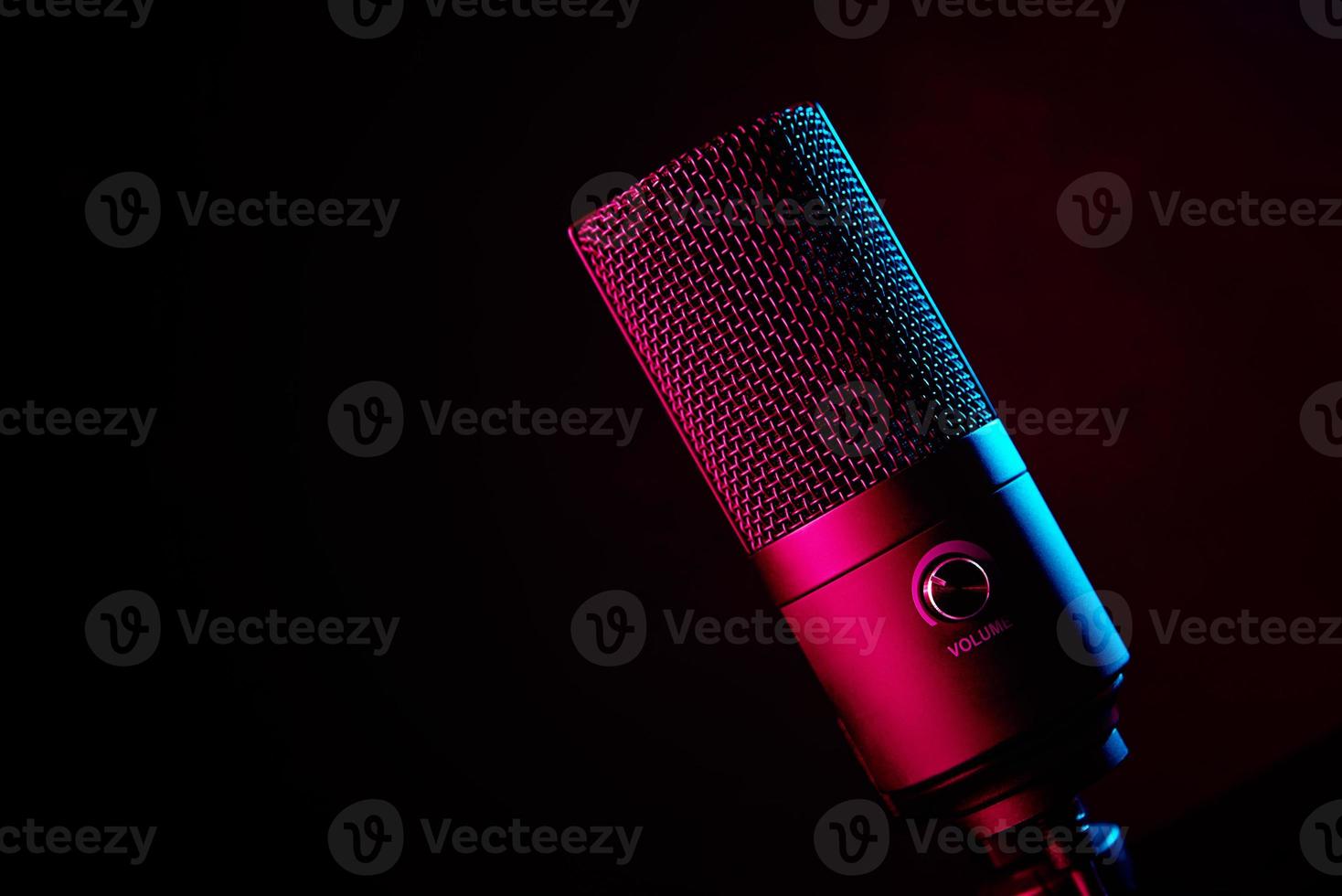 Studio microphone on dark background with neon lights photo