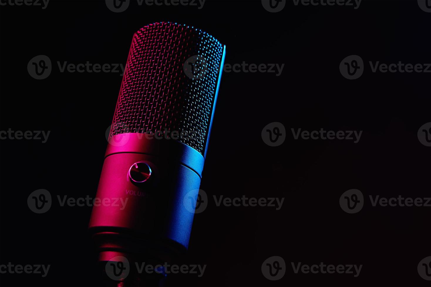 Studio microphone on dark background with neon lights photo