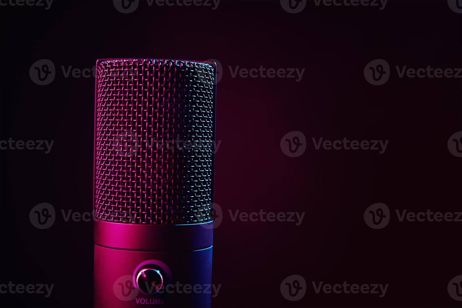 Studio microphone on dark background with neon lights photo