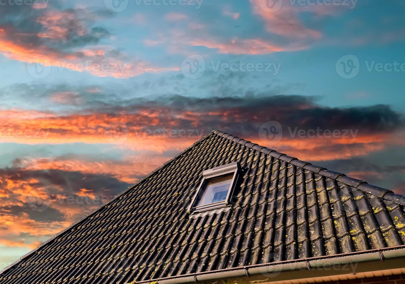 Open roof window in velux style with black roof tiles. photo