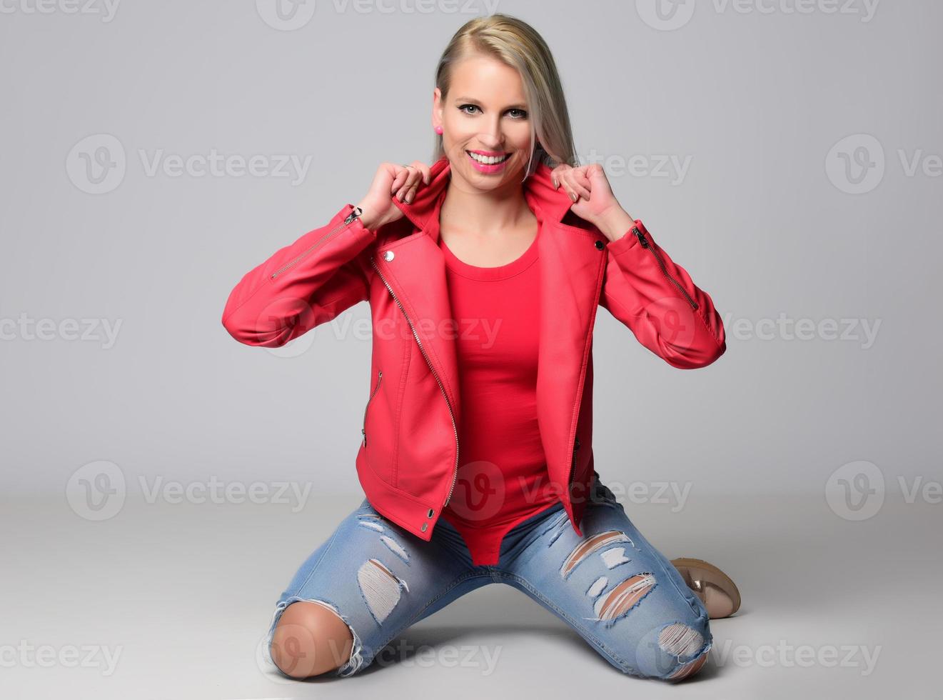 blonde trendy smiling woman wearing modern accessories posing in studio photo