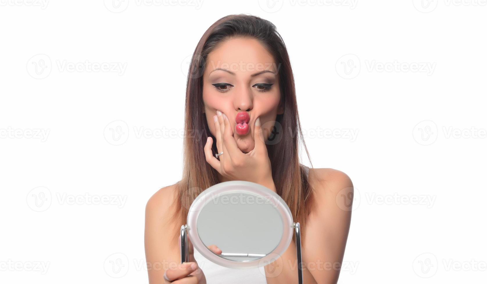 Beautiful woman sitting in front of a mirror. face of a healthy woman applying cream and makeup. Advertisement for skin cream, anti-wrinkle cream, baby face photo